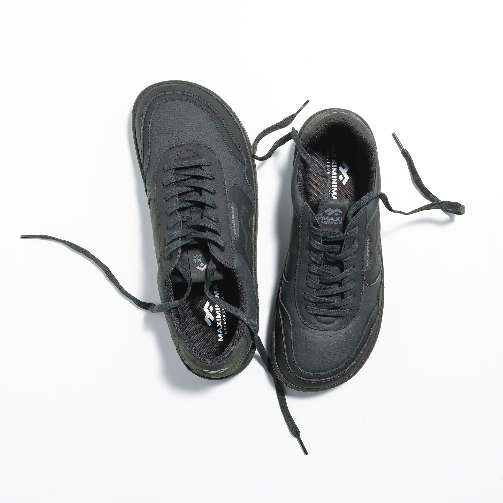 Top view of black barefoot sneakers with wide toe box and minimalist design
