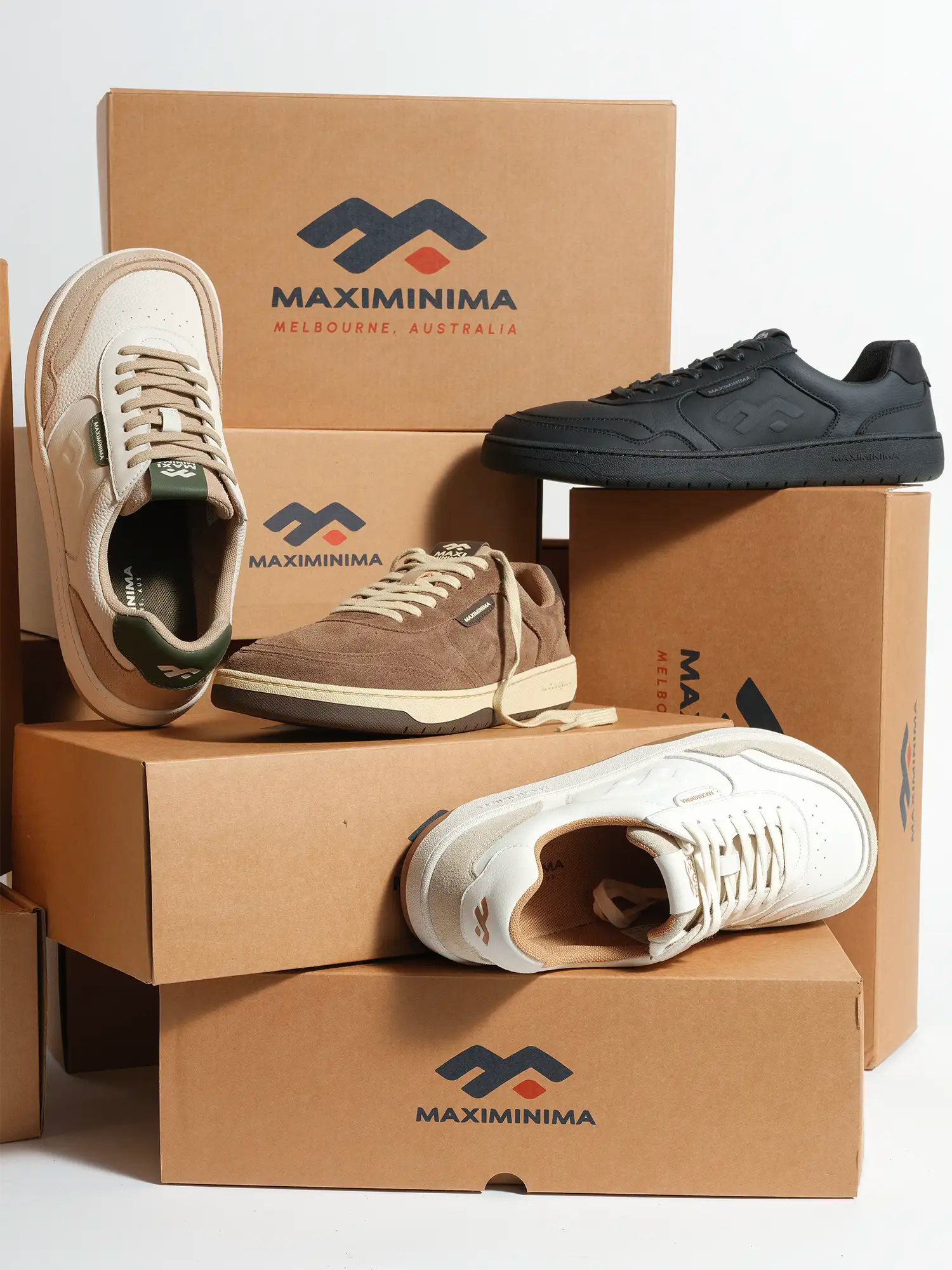 Maximinima barefoot sneakers displayed on branded shipping boxes in multiple colours