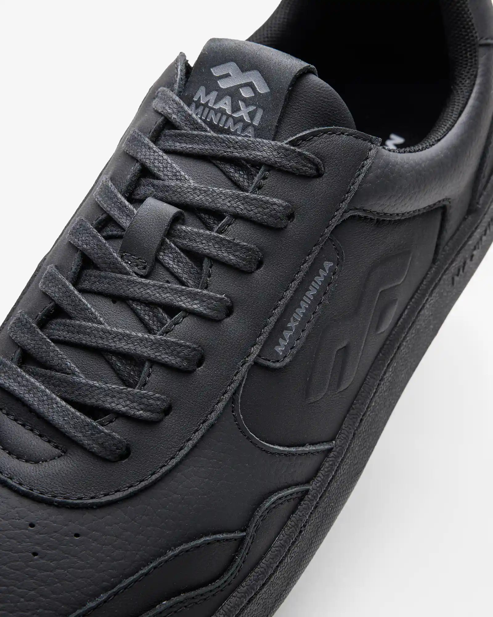 Maximinima Axis black barefoot sneaker close-up showing upper material, laces and branding detail